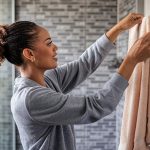 A woman shows how often to change towels in the bathroom