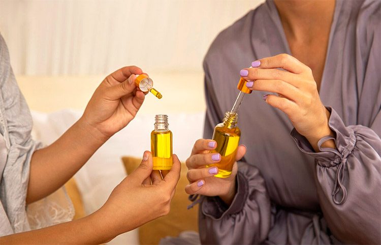 Women hands use essential oils which is the solution of how to make your home smell good