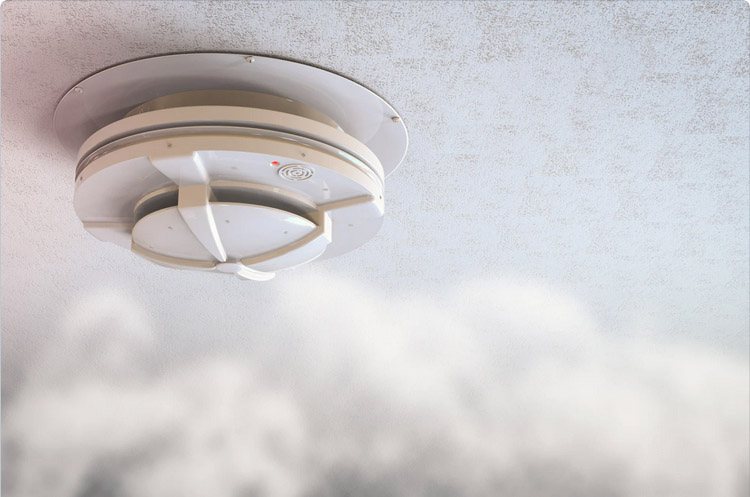 A smoke detector ensuring garage safety during potential fire hazards